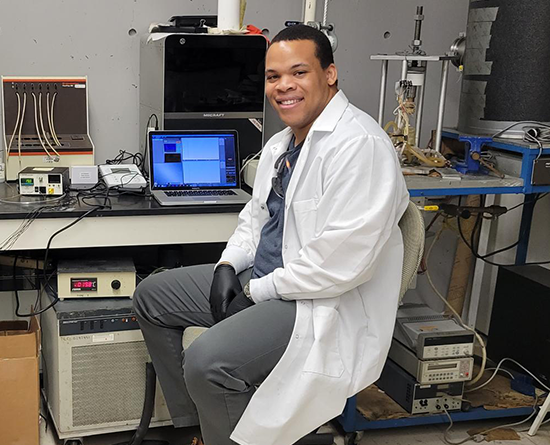 Smiling researcher sitting in his lab