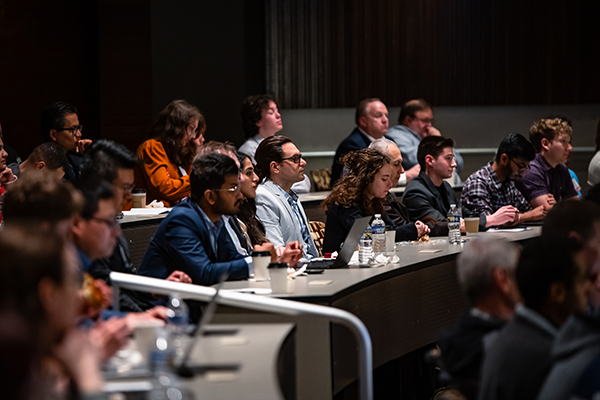 Part of the crowd sitting down during a presentation at the expo
